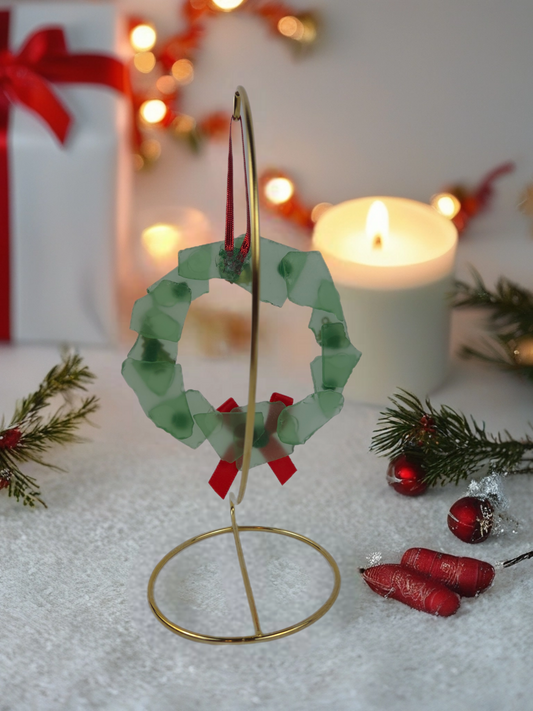 Decorative Christmas wreath ornament on a stand with festive background