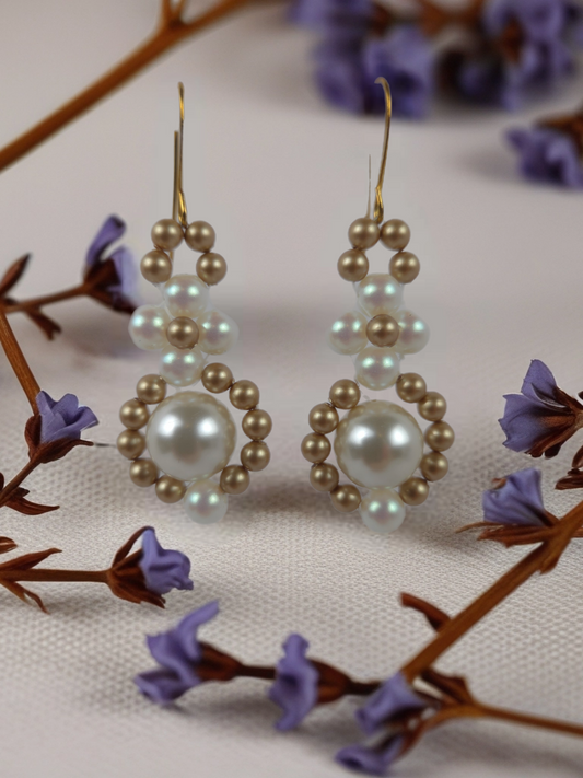 Pair of pearl earrings on a floral background